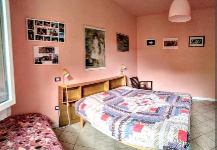 a bedroom with a bed with a quilt on it at Camera matrimoniale a due passi dal mare in Cervia
