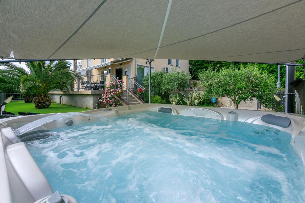 a hot tub under an umbrella in a yard at Family Heritage in Crikvenica