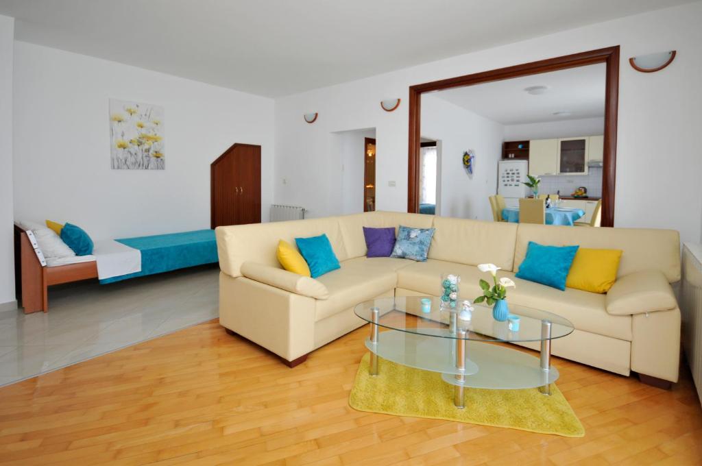 a living room with a couch and a table at Apartments Roza in Trogir