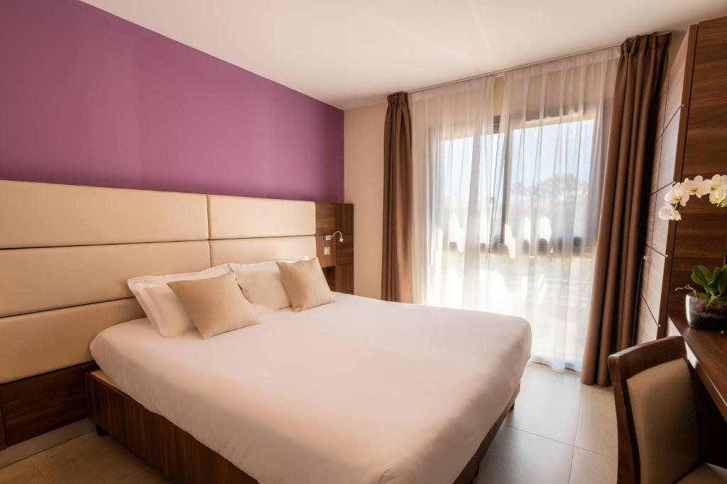 Postel nebo postele na pokoji v ubytování Hotel Port Toga