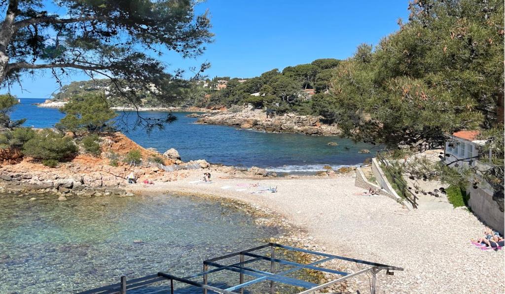 a view of a beach with people in the water at Bastide de l'Olivaie in Bandol