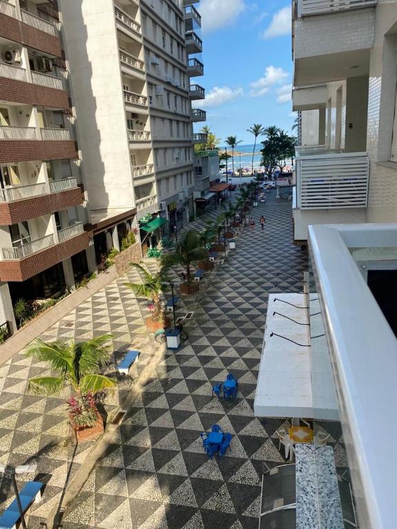 a view from a balcony of a building with a checkerboard floor at Apartamento Guarujá Pitangueiras 50 metros da Praia. in Guarujá