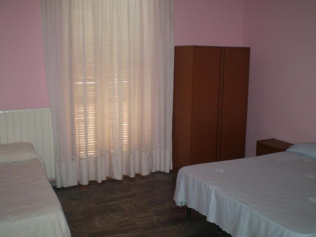 Postel nebo postele na pokoji v ubytování Hotel Tania