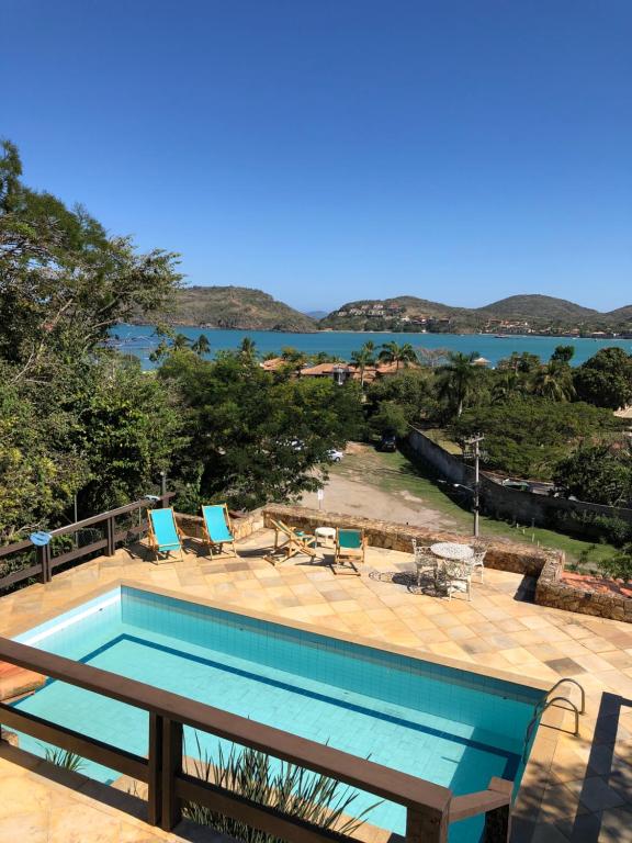 a swimming pool with a view of the water at Pousada Encanto de Búzios in Búzios