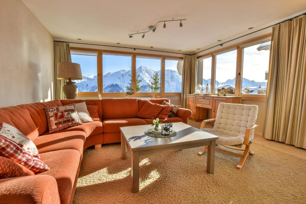 a living room with a couch and a table at Topas 7 in Bettmeralp