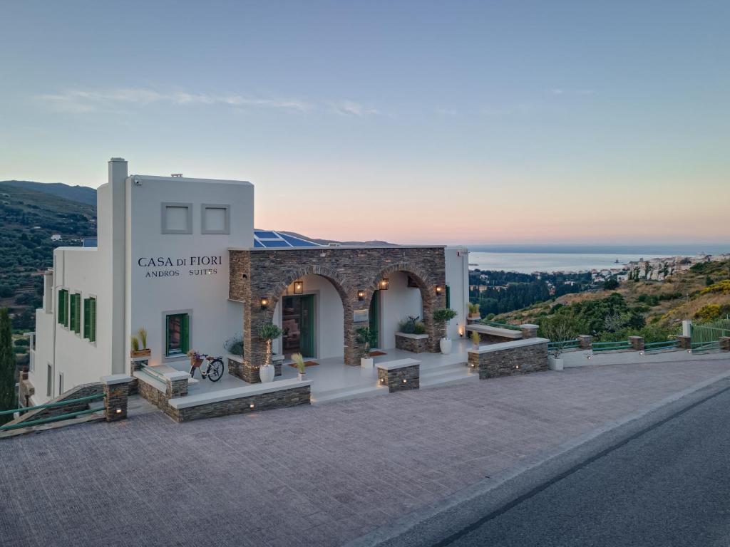 a building on the side of a hill at Casa Di Fiori Andros Suites in Andros