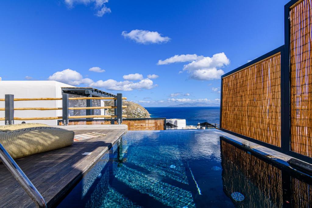 a swimming pool with a view of the ocean at Maregold Mykonos Micro-Boutique Suites, Adults Only in Elia Beach