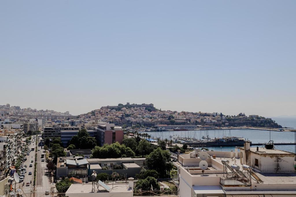 a view of a city with buildings and a harbor at Aura Celestia in Kavála