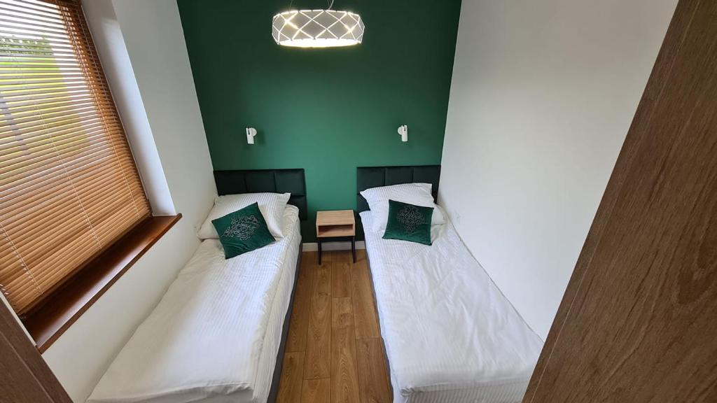 Posteľ alebo postele v izbe v ubytovaní APARTAMENTY SKORUPKI-Mazury Mikołajki