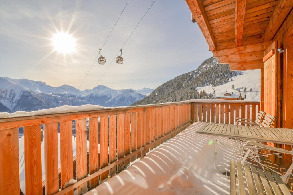 a deck with a view of the mountains at Hirschfluh Duplex in Riederalp