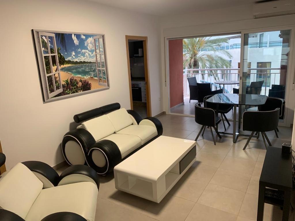 a living room with a white couch and a table at Apartamento "Pedro" 250 m de la playa in Gandía