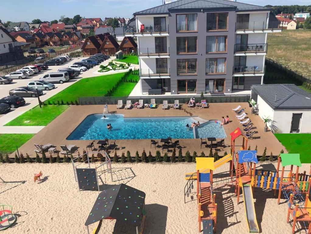 an aerial view of a playground in front of a building at Apartments Deluxe BALTIN FAMILY animacje i 2 baseny w cenie in Sarbinowo