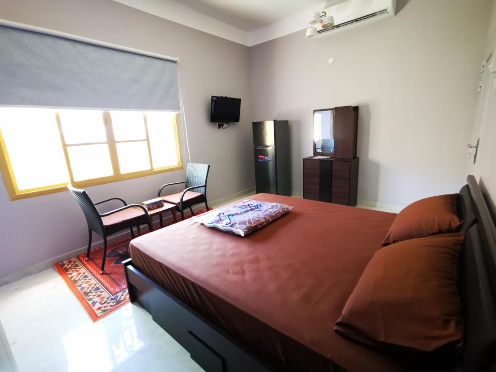 Postel nebo postele na pokoji v ubytování Al Hamra Guest House