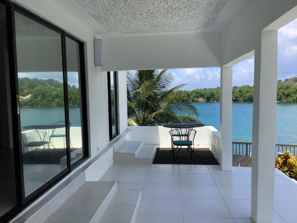 a balcony with a view of the water at Ridge Bay Chateau in Port Antonio