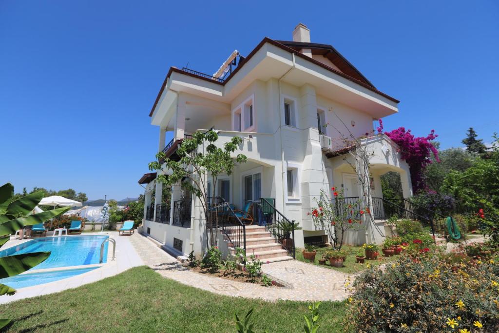 a villa with a swimming pool and a house at Villa Ruya-PrivatePool-SeaView-GamesRoom in Fethiye