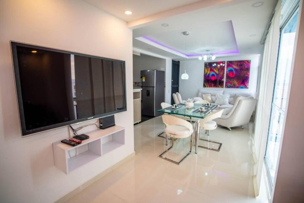 a living room with a large flat screen tv on a wall at apto vacacional in Cali