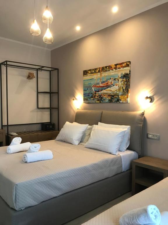a bedroom with a bed with two towels on it at Dokos Studios in Parga