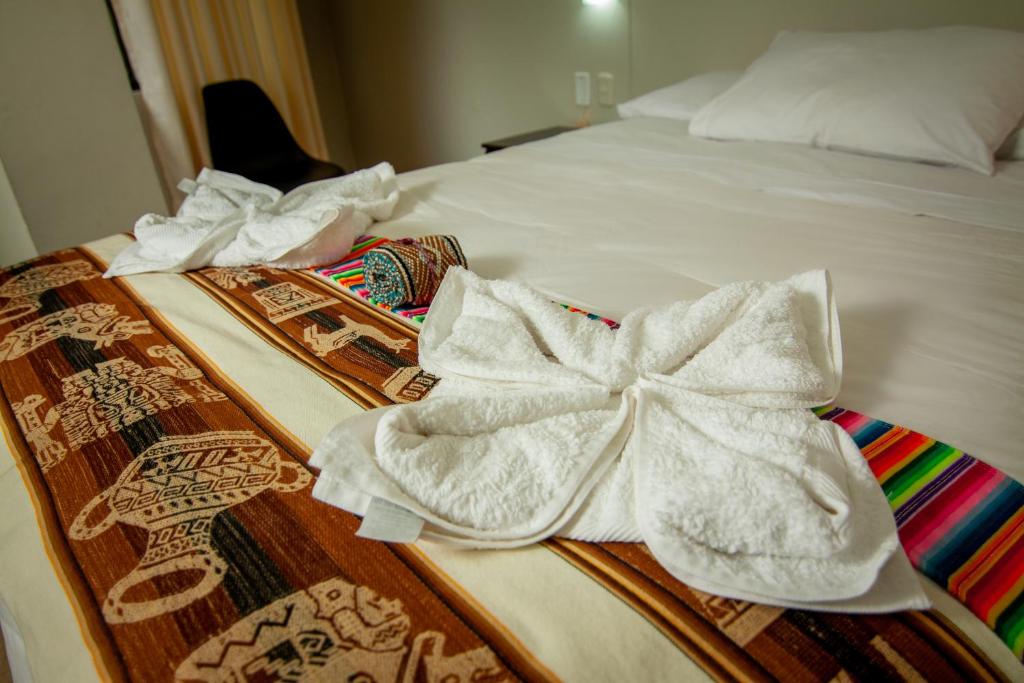 Postel nebo postele na pokoji v ubytování RUMIQOLQA Machupicchu Hotel