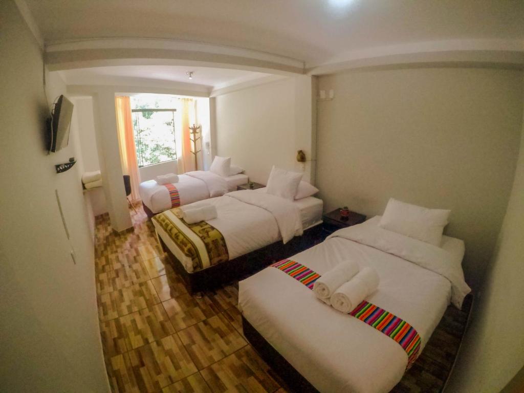 Postel nebo postele na pokoji v ubytování RUMIQOLQA Machupicchu Hotel