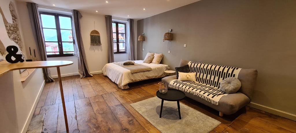 un salon avec un canapé et un lit dans l'établissement Les Chemins d'Elika, à Saint-Jean-Pied-de-Port