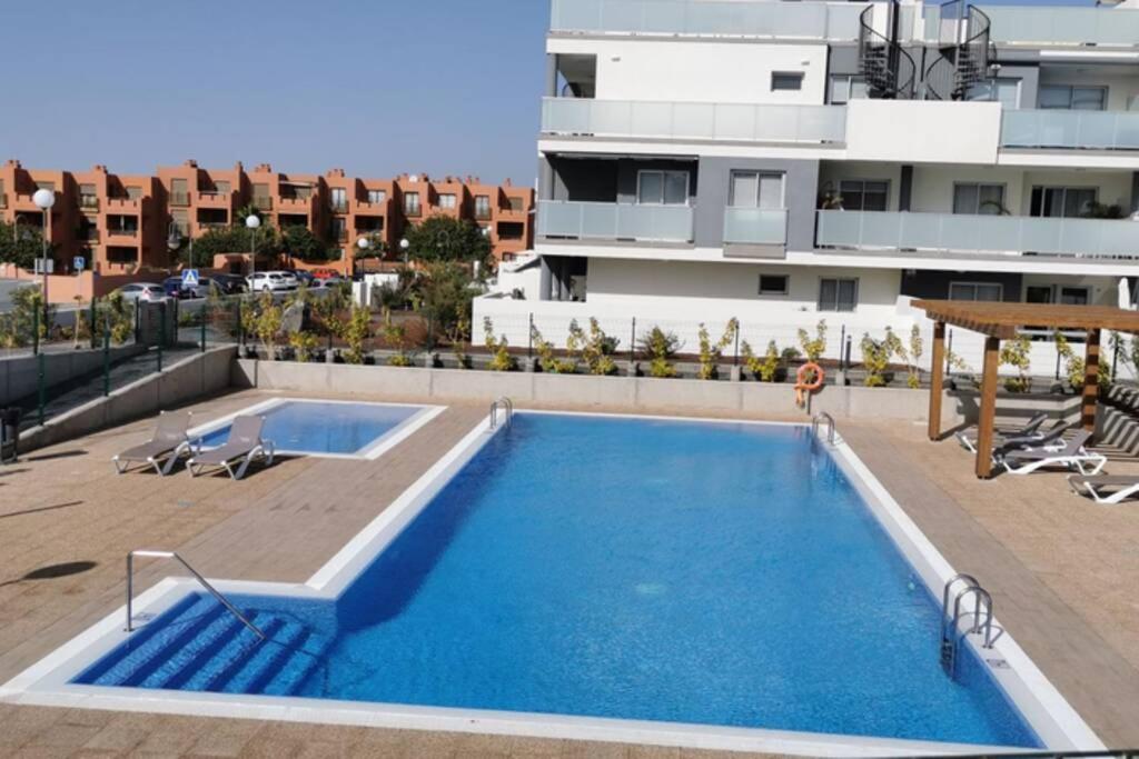 a swimming pool on the roof of a building at Divino en playa in Granadilla de Abona