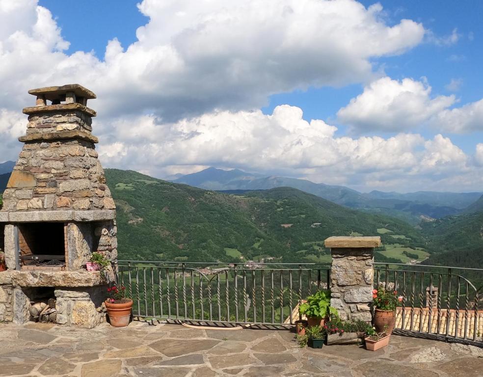 a stone oven on a balcony with mountains in the background at Apartamentos Farrai llova 