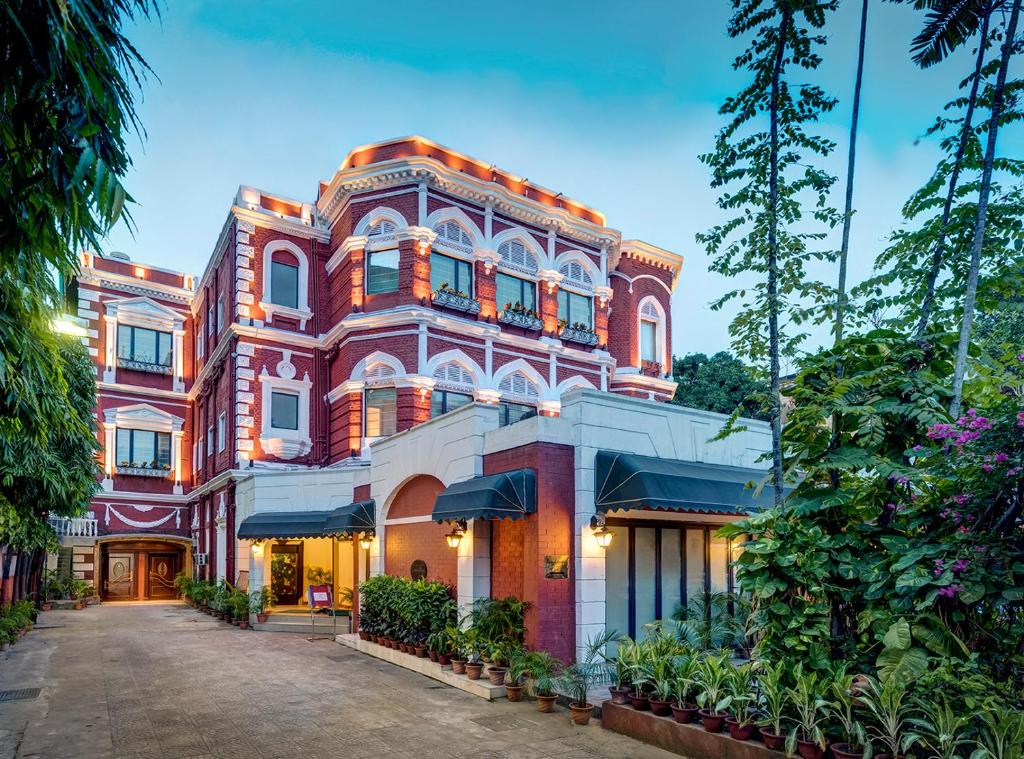 a large red brick building with a driveway at The Astor in Kolkata