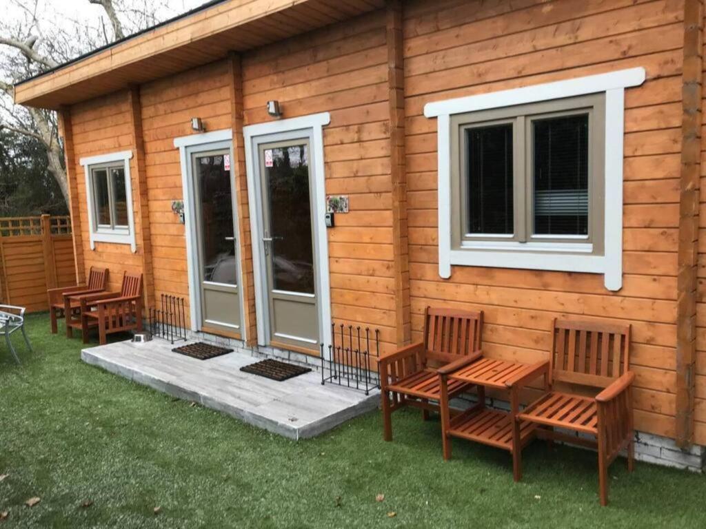 a group of benches sitting outside of a house at Immaculate cabin 5 mins to Inverness dogs welcome in Inverness