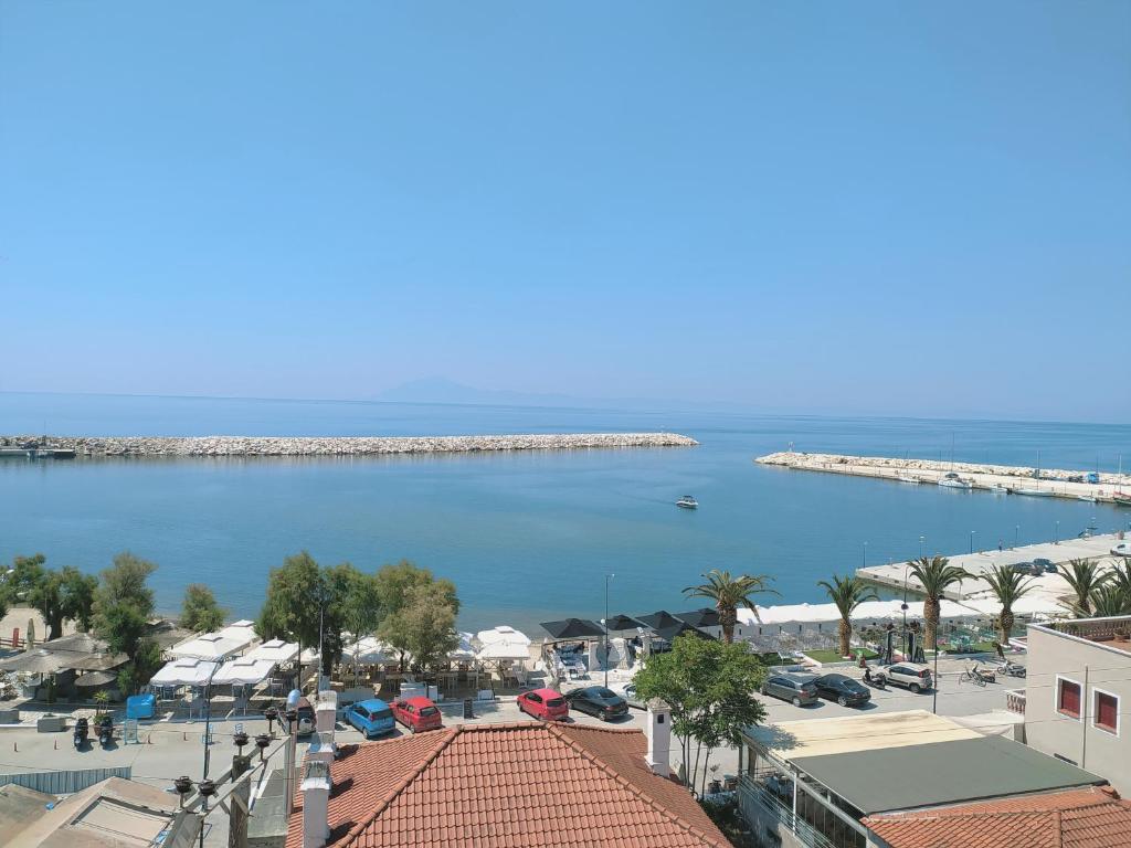 a view of the ocean and a marina at Hotel Sgouridis in Limenaria