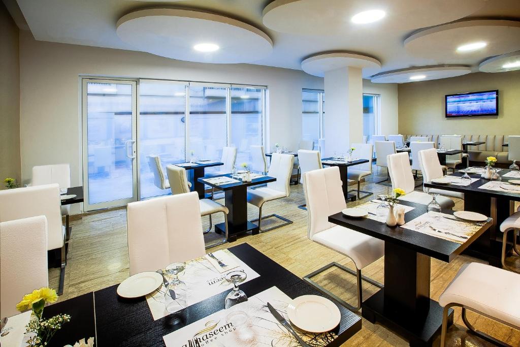 a restaurant with tables, chairs, and tables in it at Al Sarab Hotel in Dubai