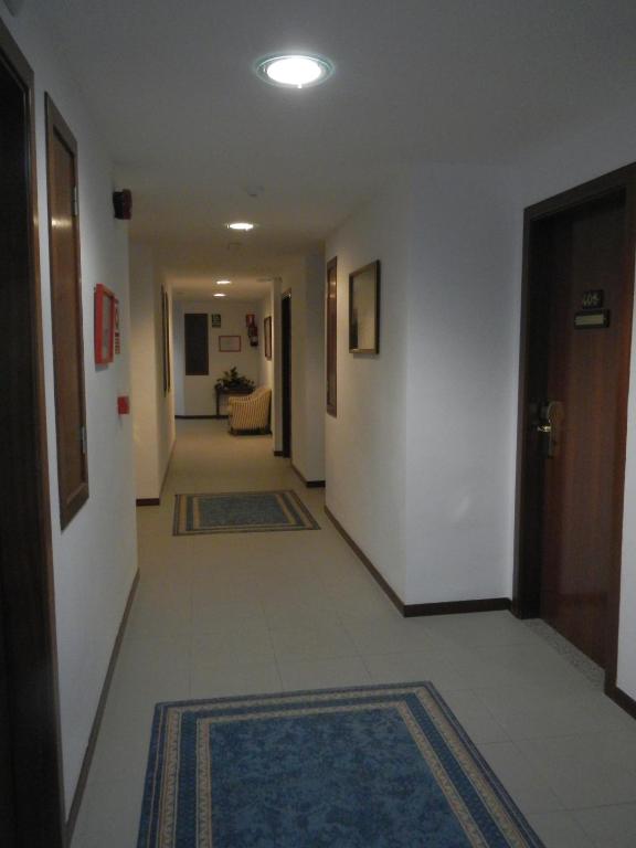 a hallway with rugs on the floor of a building at Hostal Vila del Mar in Lloret de Mar