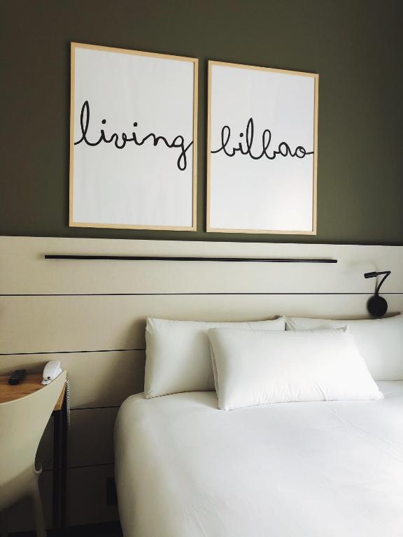A bed or beds in a room at voco Bilbao - City by IHG