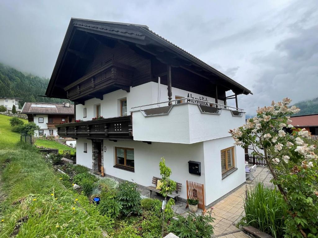 a white house with a black roof at Appartements Alpenblick in Finkenberg