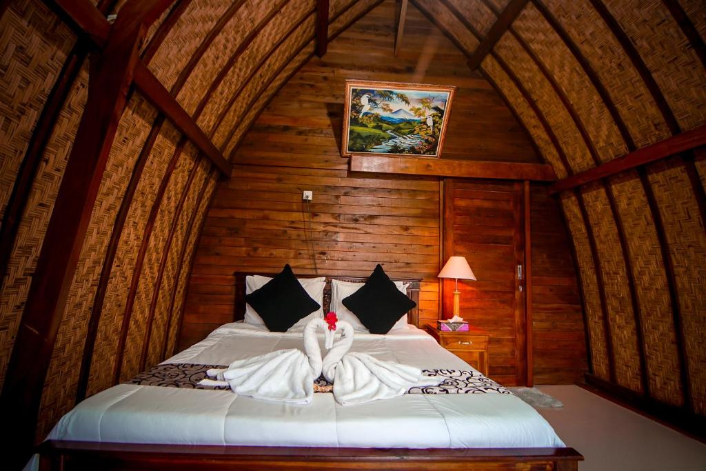 Postel nebo postele na pokoji v ubytování Pondok Bali Cottage