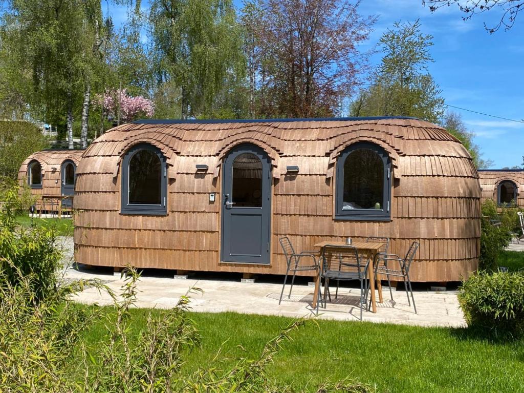 a yurt with a table and chairs in a yard at IGLUCAMPING Allgäu-Bodensee in Wangen im Allgäu