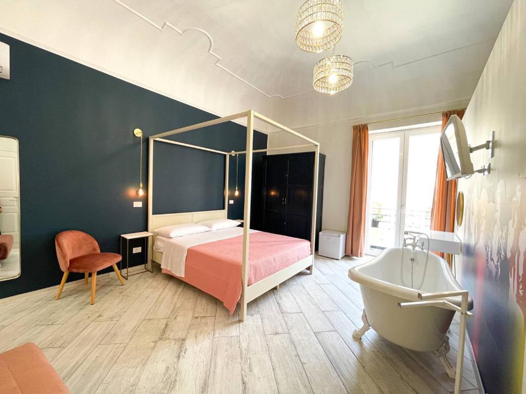 - une chambre avec un lit, une baignoire et un lavabo dans l'établissement BaRock B&B Palermo, à Palerme