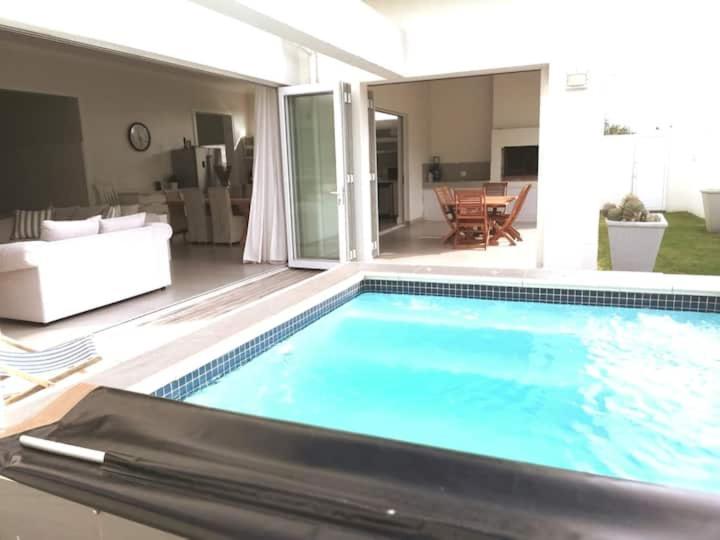 a large swimming pool in a living room at A home for the ultimate West Coast beach holiday in St Helena Bay