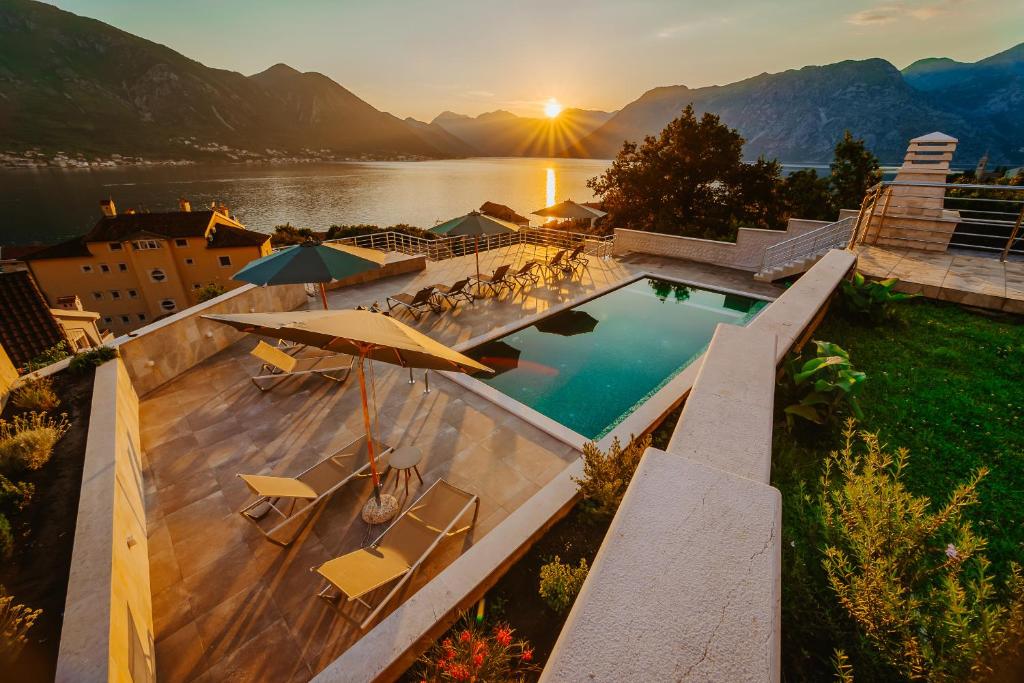 an outdoor swimming pool with a view of a lake at Apartments Casa Delone in Kotor
