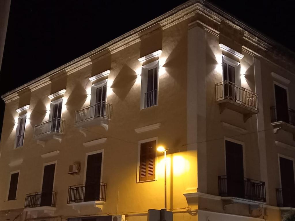 a large white building with windows and a street light at MY HOUSE LUXURY HOME in Marsala
