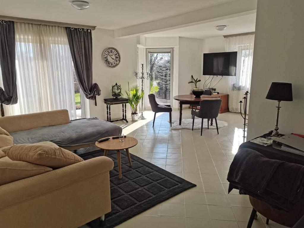 a living room with a couch and a table at Villa kerangoues gîte 3 étoiles in Sélestat