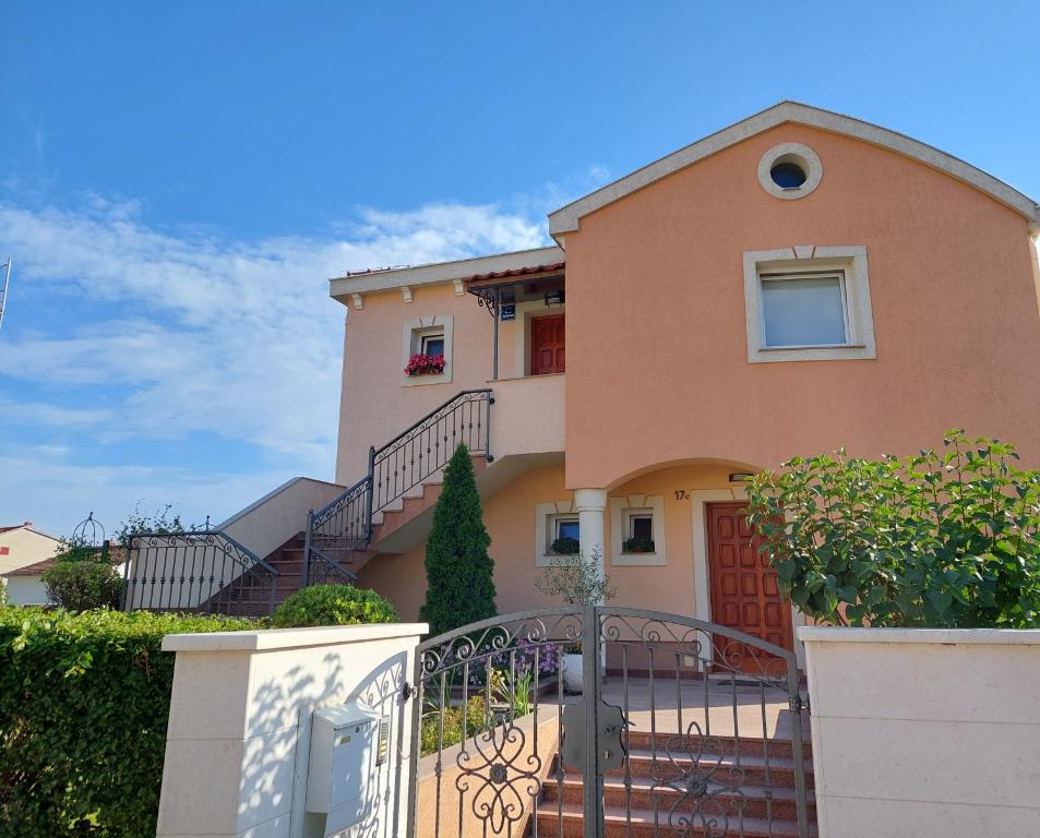 a house with a staircase in front of it at Apartment Polic in Šibenik