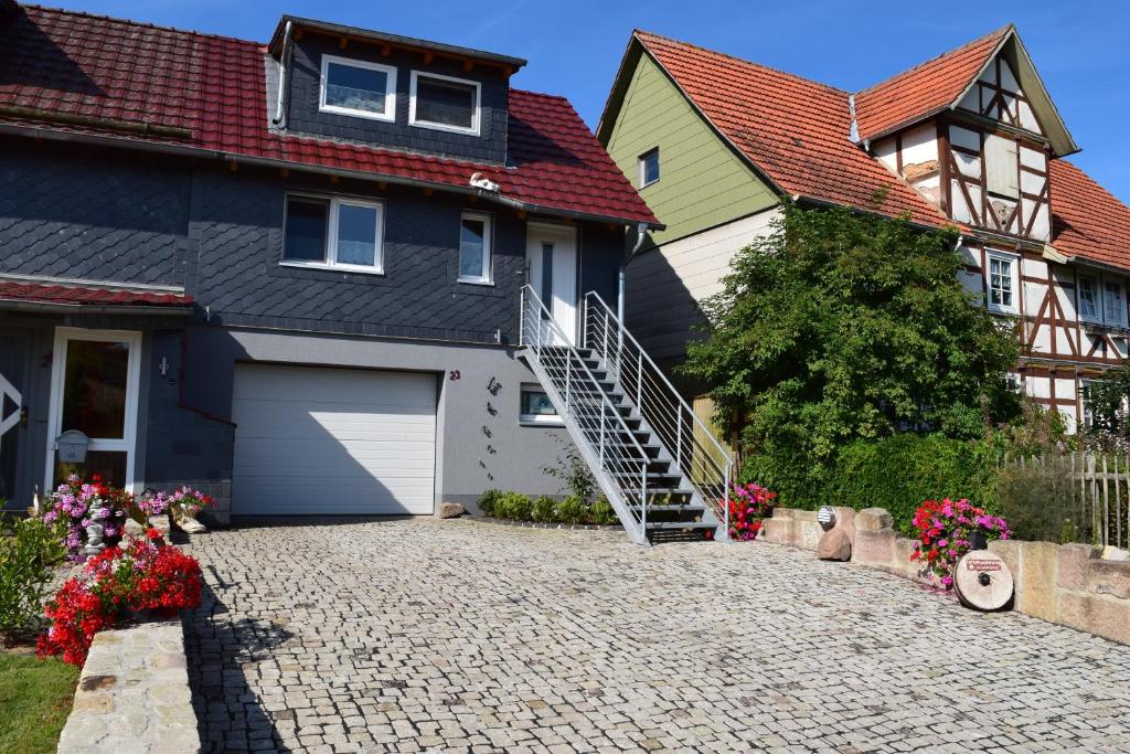 a house with a driveway and a garage at Ferienwohnung-Pension Werrablick in Witzenhausen