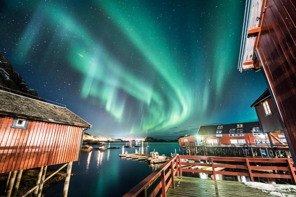 an image of the aurora borealis over a harbor at Å Hotell - by Classic Norway Hotels in Å