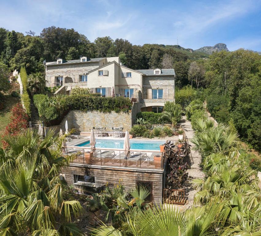 an aerial view of a house with a swimming pool at Suites in Erbalunga in Erbalunga