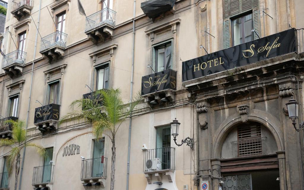 a building with a hotel sign on the side of it at Hotel Sofia in Catania