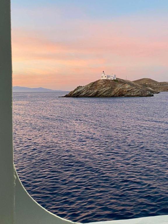 a house on an island in the middle of the water at AEGEAN VIEW SEASIDE ROOMS AND STUDIOS KEA in Korissia