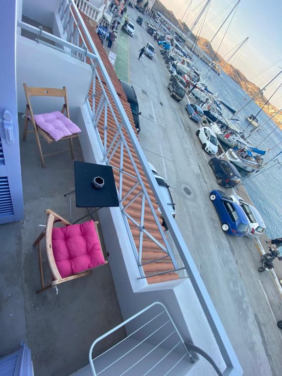 a balcony on a ship with a bed and a street at AEGEAN VIEW SEASIDE ROOMS AND STUDIOS KEA in Korissia