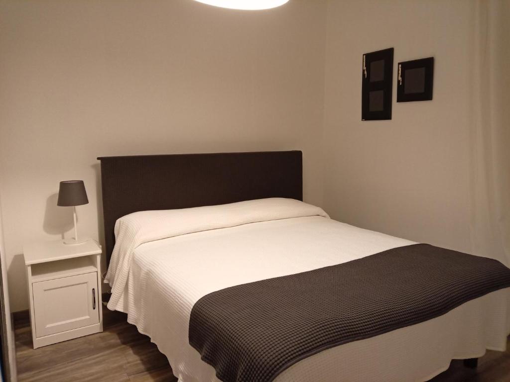 a bedroom with a bed with a black and white blanket at La Cjase di Pieri e Vilme in Udine