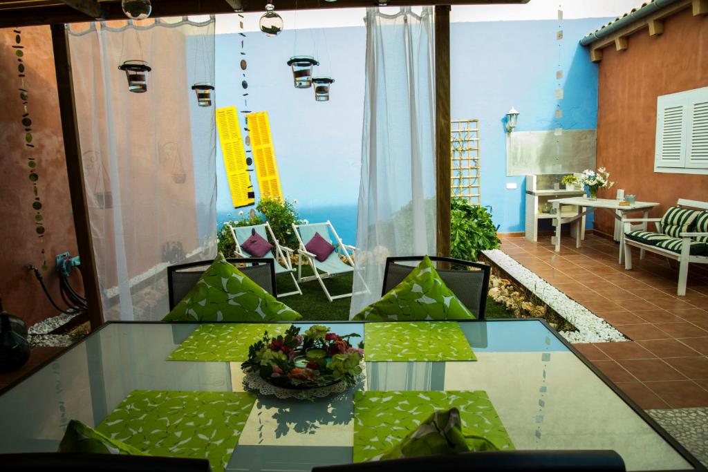 a room with a glass table and chairs in a room at Fonoll Mari in S'Illot