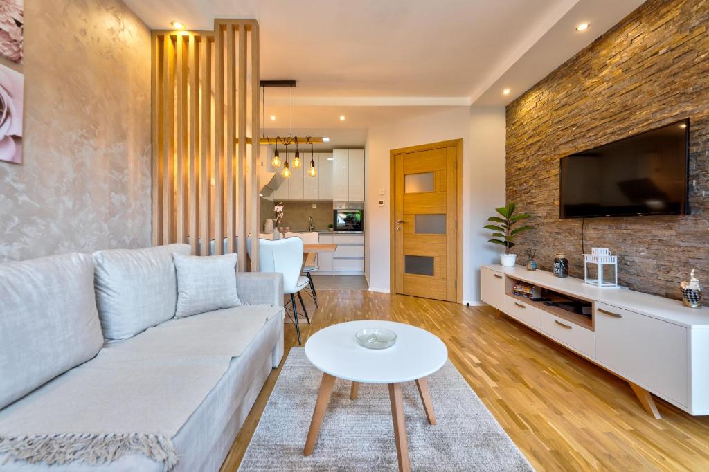 a living room with a couch and a table at Carpe Diem in Zlatibor